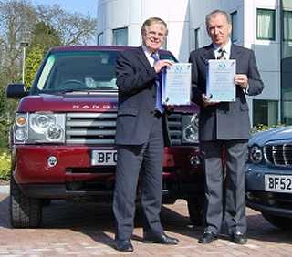 Bob Dover, Chairman and CEO of Jaguar and Land Rover accepts certificates from Derek Harvey, Chief Executive, VCA
